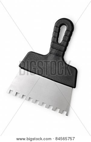 Notched Trowel With A Black Handle On A White Background