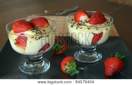 Dessert vanilla pudding with fresh strawberries