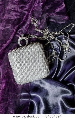 White Clutch Inlaid Diamonds On Silk Background
