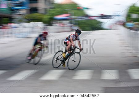 Motion Blur Of Teen Cyclist Racing In Athens Twilight Criterium
