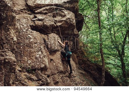 Sporty Young Woman Climbing Outdoor