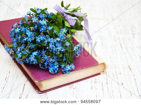 Bunch Of Forget-me-not Flowers And Old Book