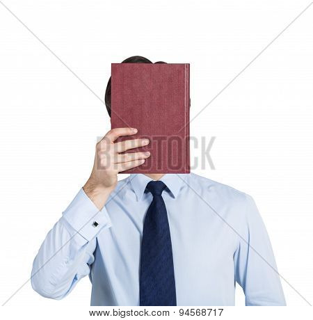A Person Holds A Red Book In Front Of The Head. Isolated.
