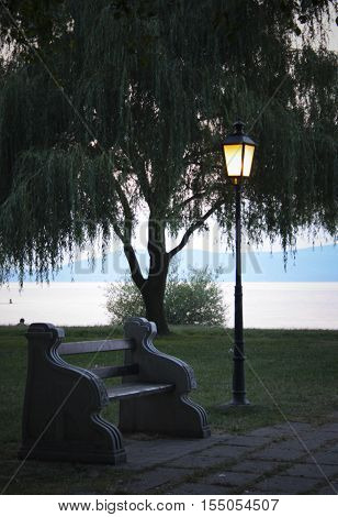 peaceful lakeside still life in sunset, with candelabra