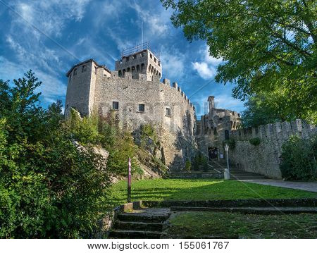 Rocca Guaita in the Republic of San Marino. Italy. View of the tower framed by tree branches.
