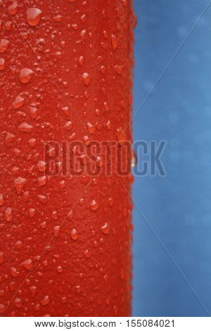 red and blue metallic background with drops of water