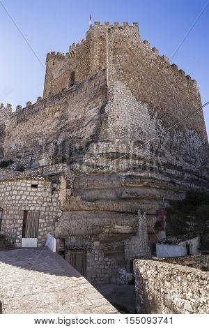 Alcala del Jucar Spain - October 29 2016: typical house of La Mancha placed in the skirts of the castle on top of limestone mountain is situated Castle of the 12TH century Almohad origin take in Alcala del Jucar Albacete province Spain