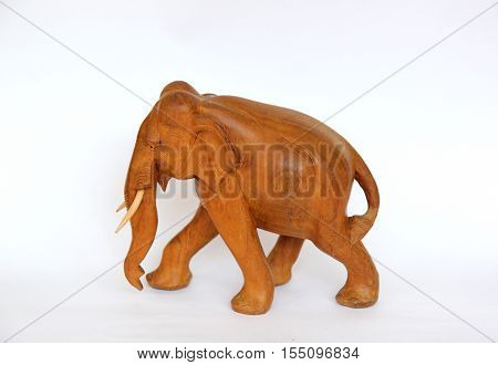 Wooden handmade elephant statue isolated on white is waling in Africa