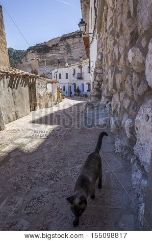 Alcala del Jucar Spain - October 29 2016: Narrow street with white painted houses typical of this town take in Alcala of the Jucar Albacete province Spain