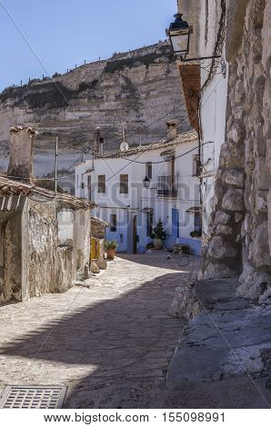 Alcala del Jucar Spain - October 29 2016: Narrow street with white painted houses typical of this town take in Alcala of the Jucar Albacete province Spain