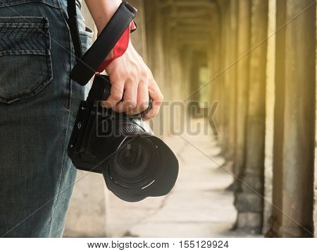 photographer holding his camera in his right hand