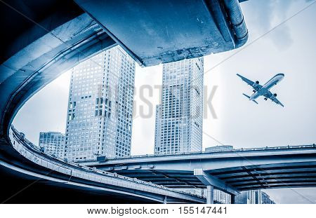 blurred street scene in city with a plane flying over in city of China.