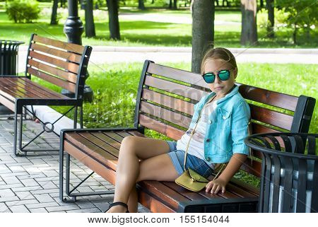 Portrait Of A Girl With Glasses On The Background Of  Tree Park