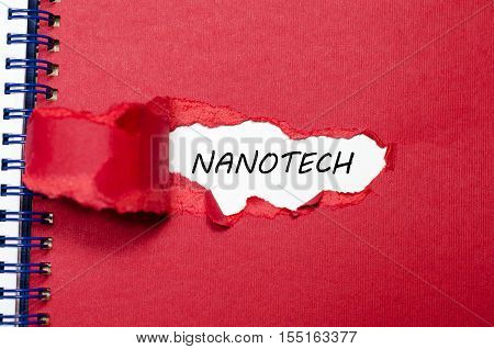 The word nanotech appearing behind torn paper