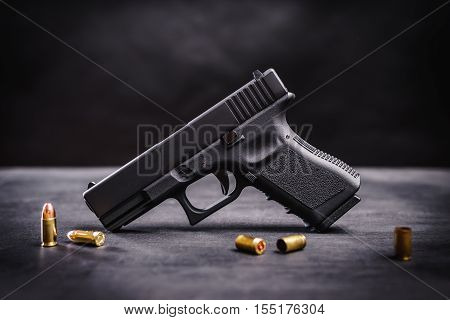 black 9mm pistol on a black wooden table