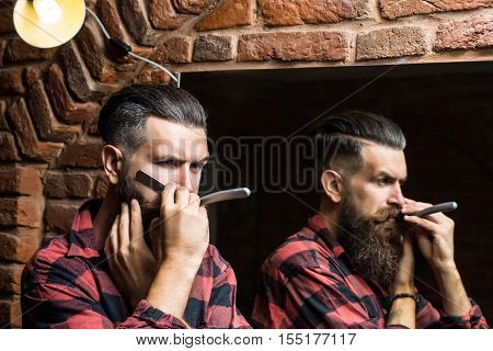 Man With Razor Near Mirror