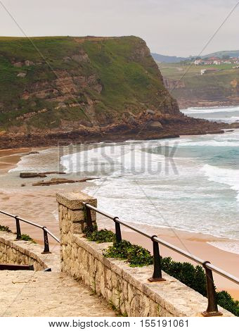 View of the sandy beach in cloudy foggy day. Spain suburb of Suances summer day in the Province of Cantabria it is photographed from Playa de Los Locos.