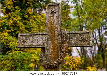 Uzhgorod Ukraine - November 1 2016: Old cast iron cross on the old cemetery during the celebration of the Day of All Saints.