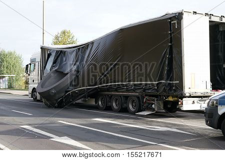 MAGDEBURG, GERMANY - NOVEMBER 01, 2016: Accident of a heavy load transporter in the inner city of Magdeburg. The charge slipped and fell on the road