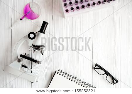 doctor workplace at wooden table with microscope in lab top view no one