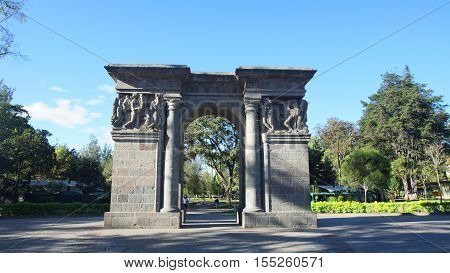 Quito, Pichincha / Ecuador - November 6 2016: Old stone gate at the entrance of the park El Ejido in the north of the city of Quito