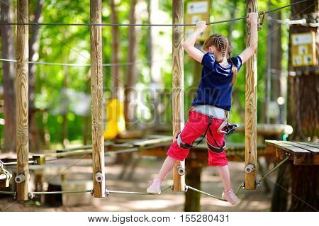 Adorable Little Girl Enjoying Her Time In Climbing Adventure Park