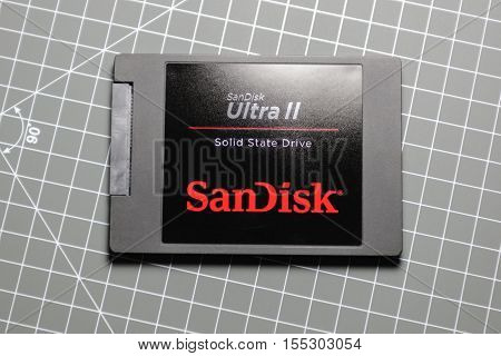 PARIS FRANCE - DECEMBER 4 2015: Modern Ultra fast SanDisk Ultra II SSD Solid State drive on table. SanDisk is an American manufacturer of flash memory products including memory cards and readers USB flash drives and solid state drives.