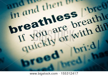 Close Up Of Old English Dictionary Page With Word Breathless