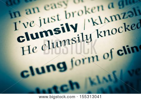 Close Up Of Old English Dictionary Page With Word Clumsily