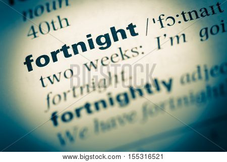 Close Up Of Old English Dictionary Page With Word Fortnight