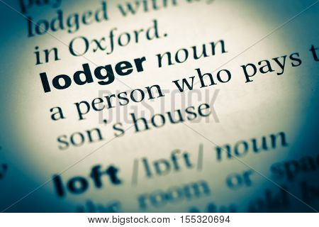 Close Up Of Old English Dictionary Page With Word Lodger