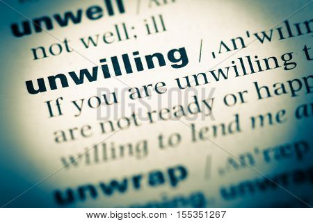 Close Up Of Old English Dictionary Page With Word Unwilling