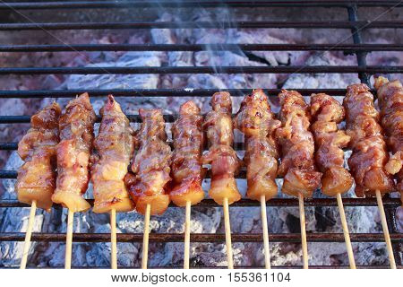 Smoke of Thai styled pork babeque on grille