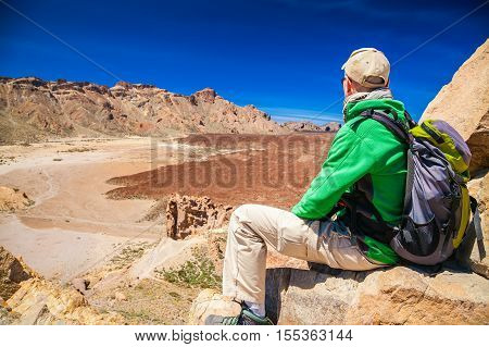 tourist man looking at the Liano de Ucanca mountains Tenerife Canary Islands Spain