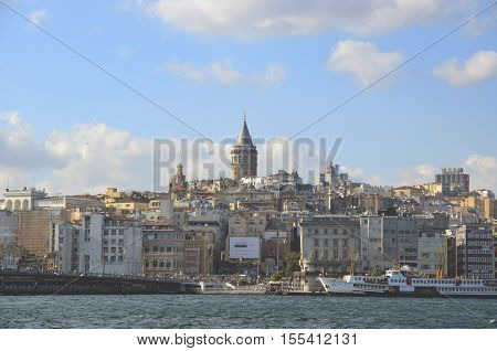 Istanbul Turkey - July 26 2016: Galata Bridge and Galata Tower in the background Istanbul views. This is a great place to see the colors of Istanbul. Interesting to see the fishermen on the bridge with the Galata tower in the background. 