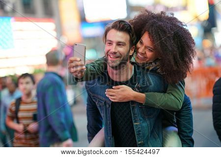 Couple at Times Square taking selfie picture