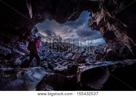Woman Exploring Dewdrop Cave Craters Of The Moon National Idaho