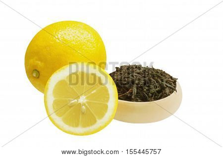 Tea leaves and two lemon, isolated on white background