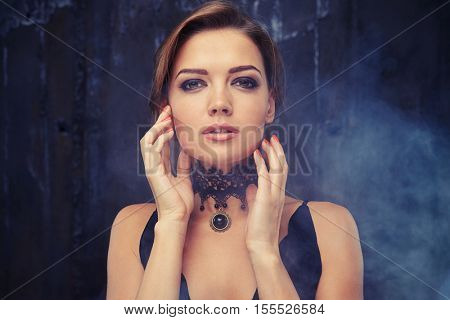 Close-up portrait of beautiful sensual woman with elegant hairstyle. Perfect make-up. Eveningwear with jewelry