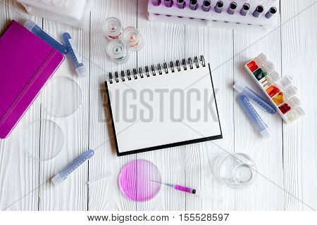 medical student working place with blank open notebook at wooden table top view