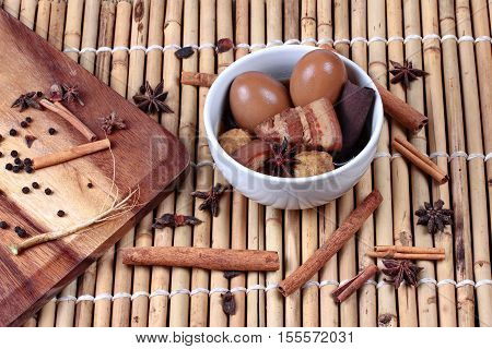 Thai Recipes : Stewed boiled egg with tofu and streaky pork call Khai Palo in Thai take photo with herbs as Chinese star anise cinnamonblack peppercilantro roots and stems is popular Thai food served