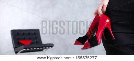 Woman's Hand Taking Red High-heels