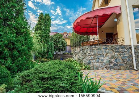 Beautiful house with a lawn. Facade of home with grass in the foreground. at sunset and sunrise. Close up