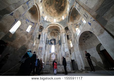 VAN,TURKEY-APRIL 28: Unidentified tourists visiting the Akdamar Church.Armenian Church of the Holy Cross stands on Akhtamar Island (Akdamar) in Lake Van on April 28,2015 in Van,Turkey.