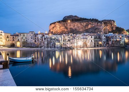 View on habour and old houses in Cefalu at night, Sicily. Beautiful townscape of old italian town. Travel photography.