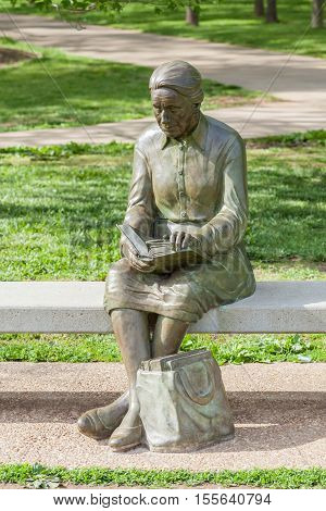 Springfield Missouri USA- May 18 2014. Reading woman statue in Nathanael greene park Springfield Missouri.