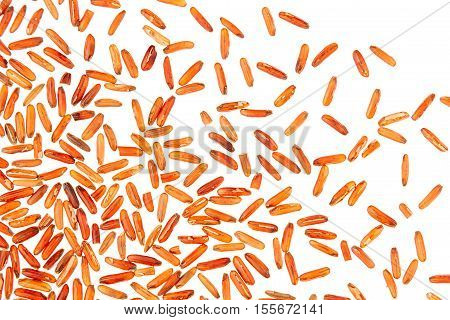 Red rice close-up on white background. Pattern wild brown unpolished rice for vegetarians.