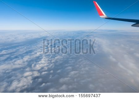 Clouds and sky as seen through window of an aircraft