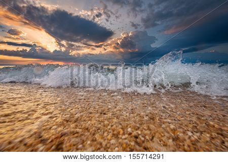 Colorful beach destination sunrise or sunset with beautiful breaking waves