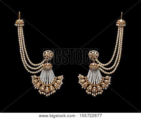 Pair of Earrings with diamonds isolated over black background